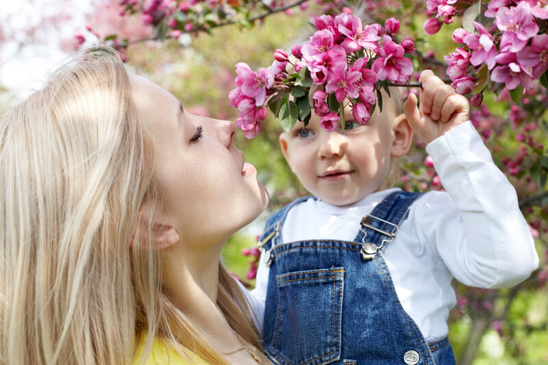 Woman and Child Smelling Flowers
