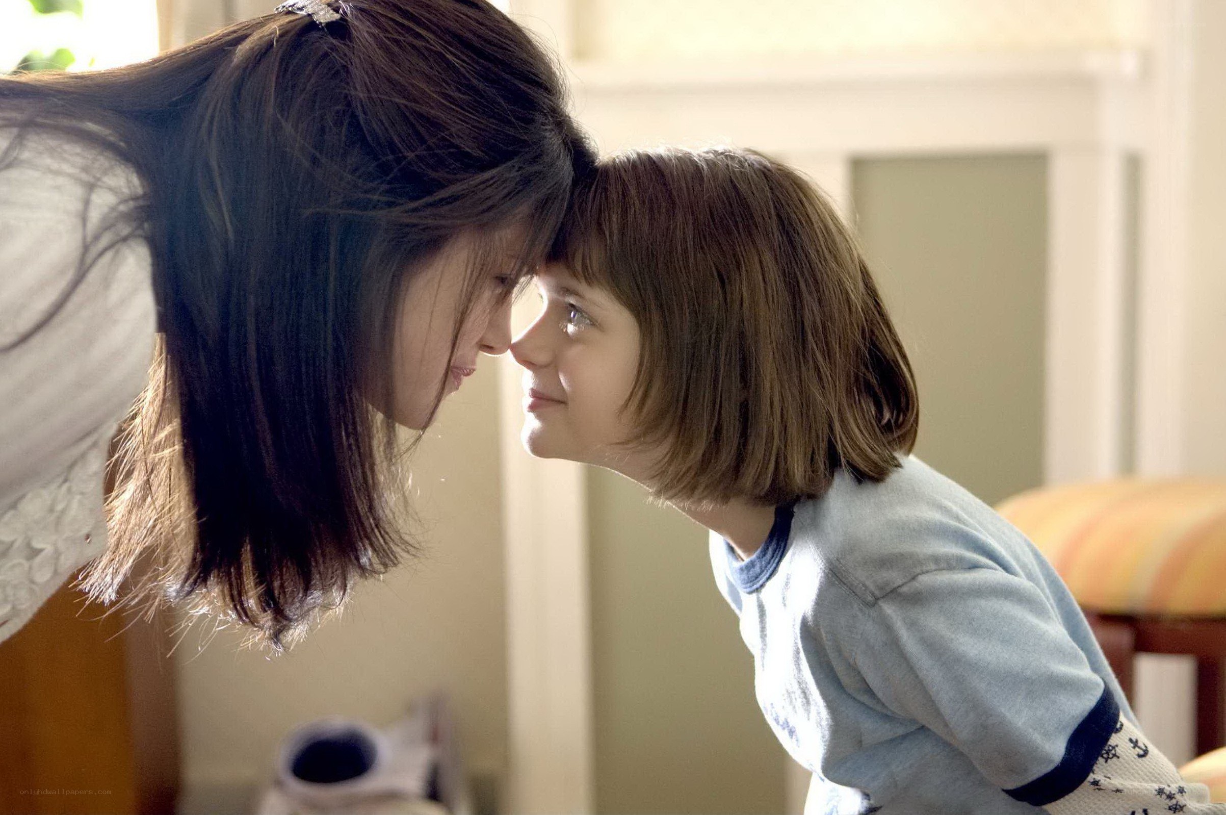 woman and child touching foreheads