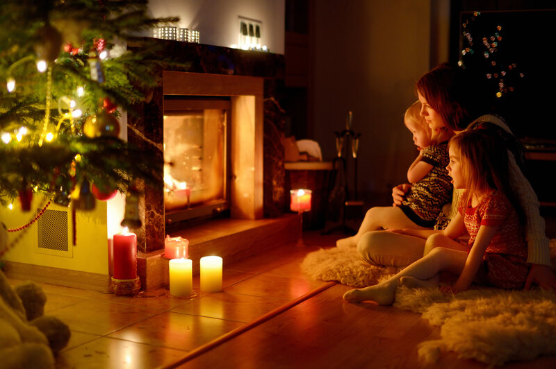 Woman and Children by Fireplace