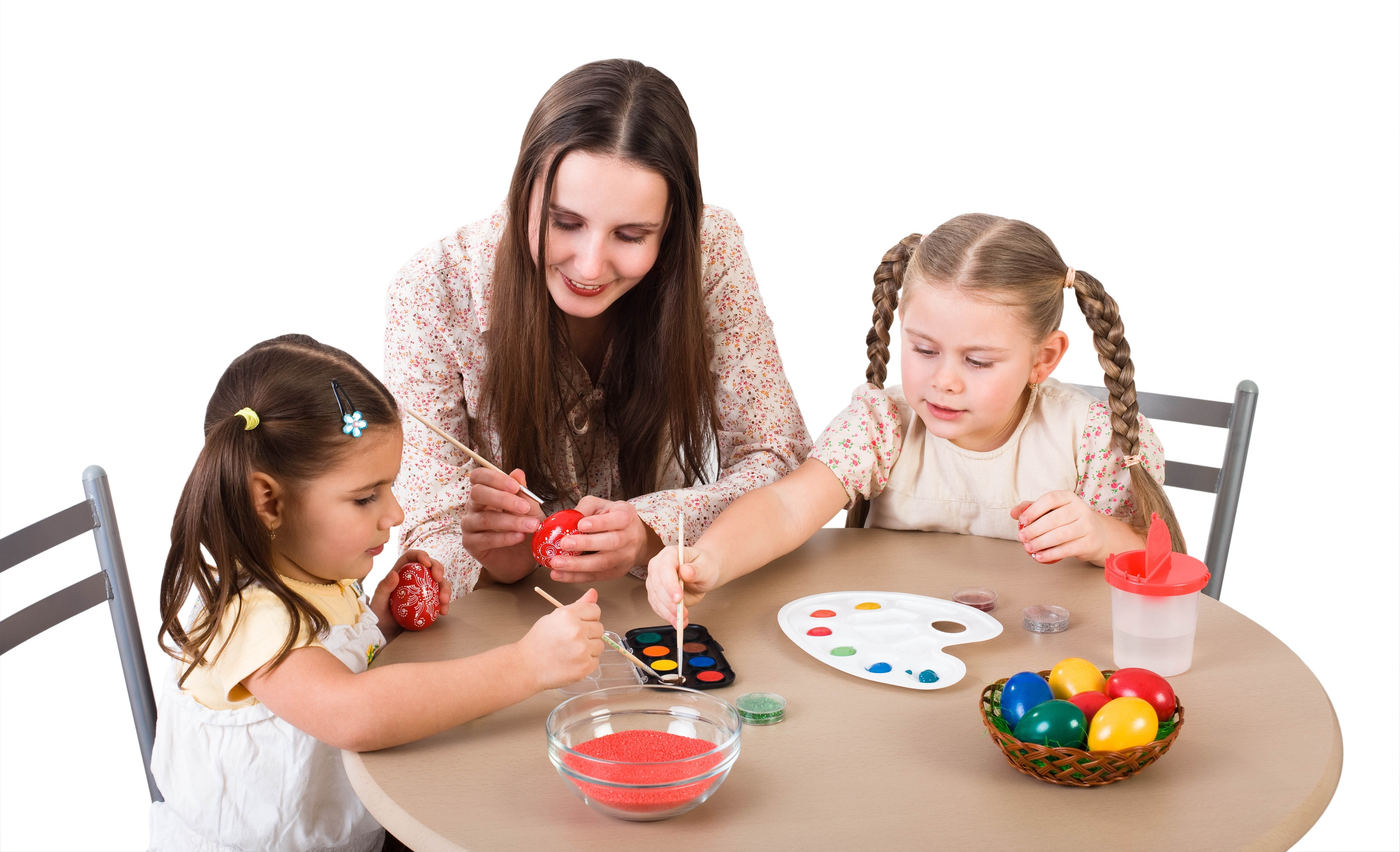 woman and children painting eggs