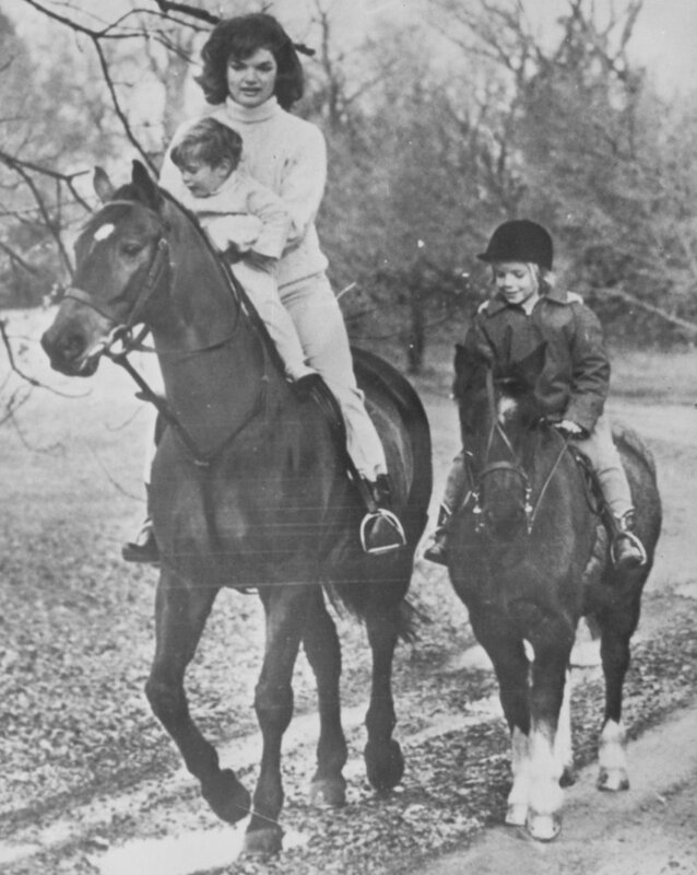 Woman and children riding horses