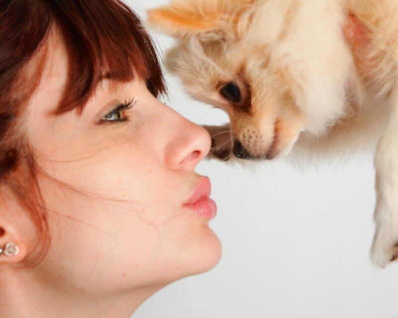 woman and dog nuzzling