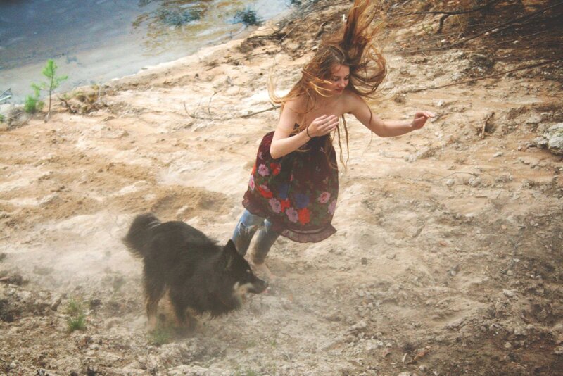woman and dog on a hillside