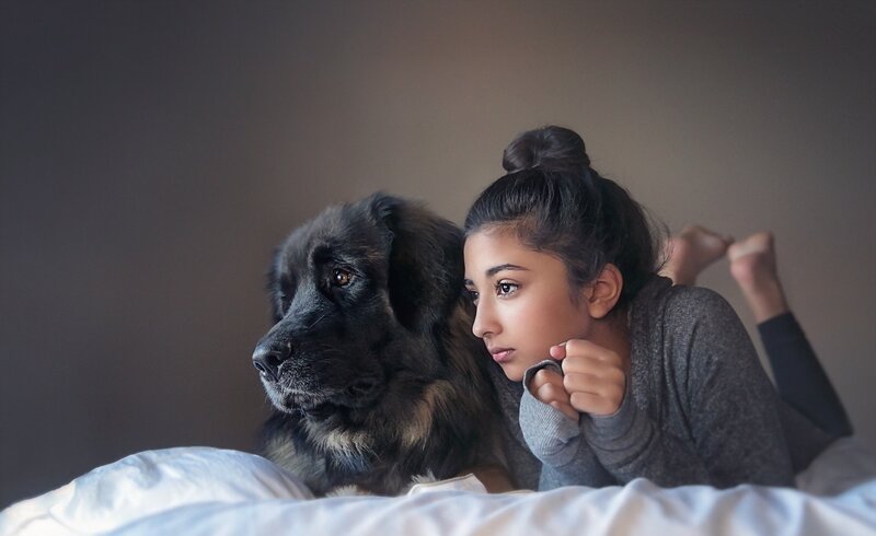 Woman and Dog on Bed