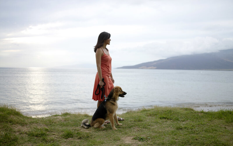 Woman and Dog on Cliff