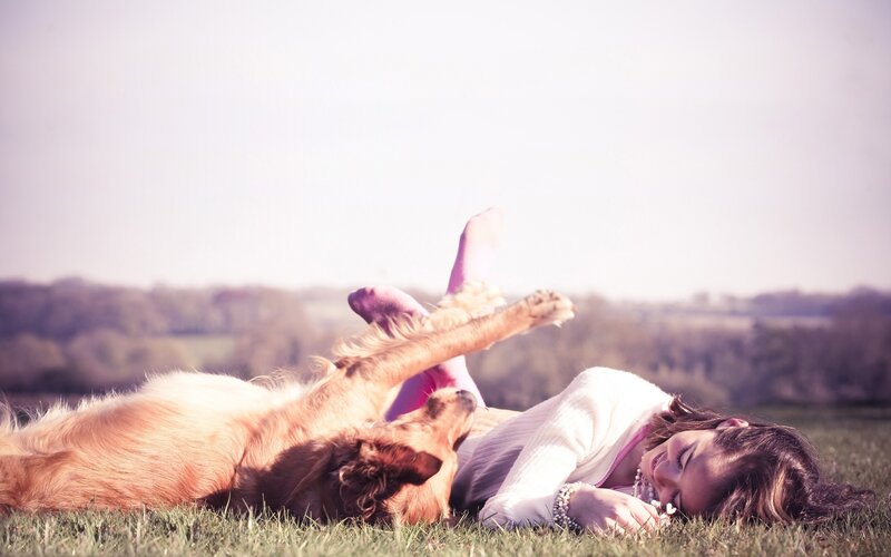 Woman and dog on grass