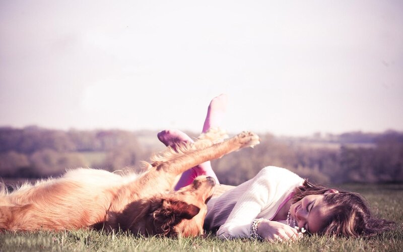 Woman and dog on grass