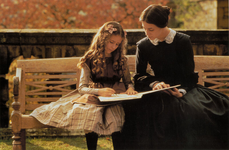 woman and girl drawing on bench