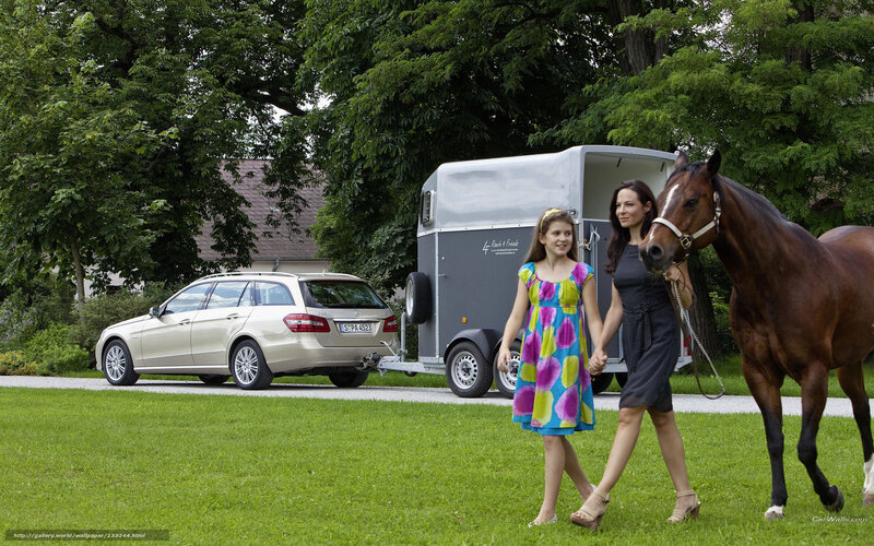 woman and girl walking with horse