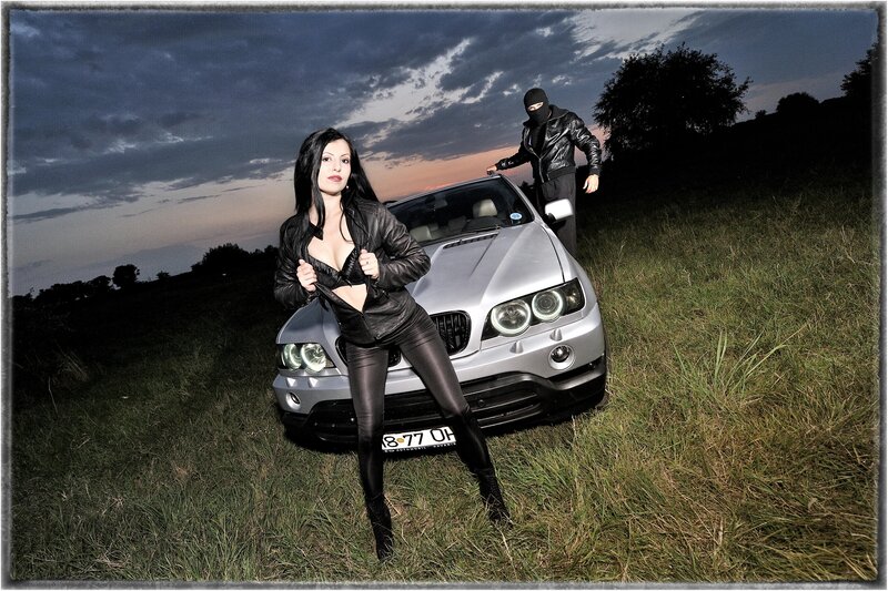 Woman and masked man with car