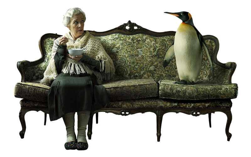 Woman and penguin on a sofa