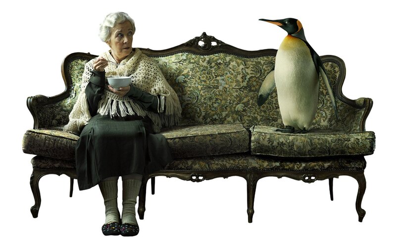 Woman and penguin on a sofa