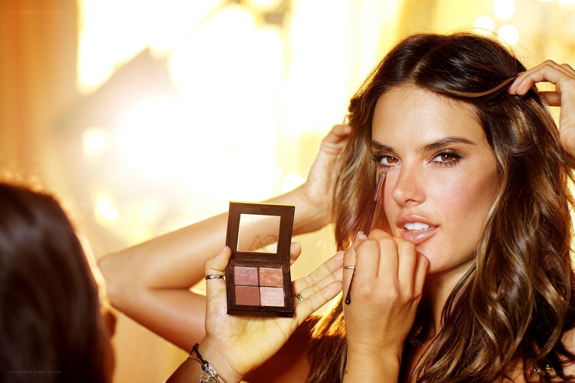 woman applying eye makeup