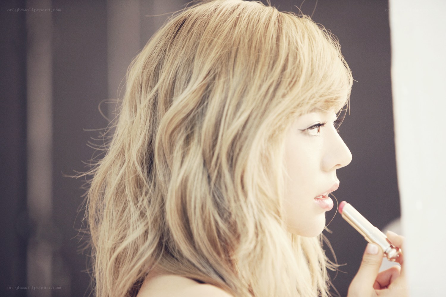 woman applying lipstick