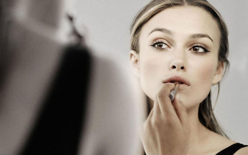 Woman Applying Lipstick — Black, Focused