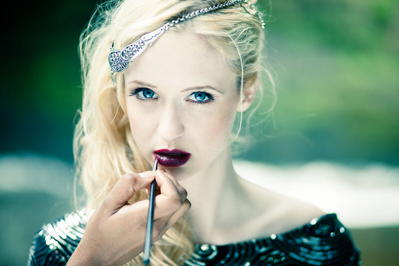 Woman Applying Lipstick — Blue, Dramatic, Photograph