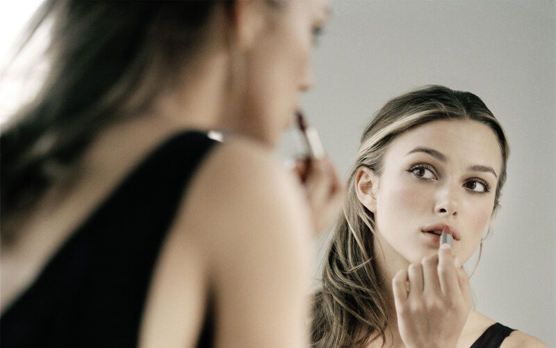 Woman Applying Lipstick — Gray