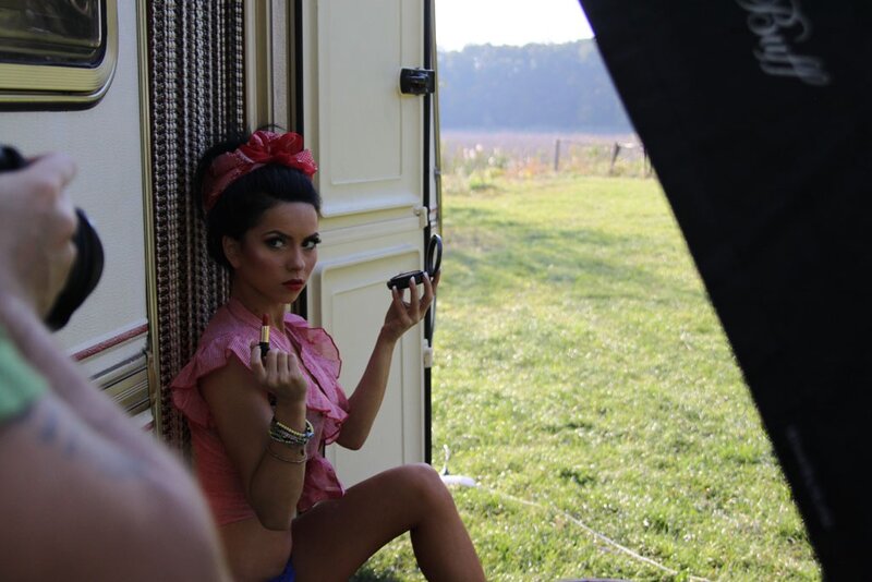 woman applying lipstick in camper