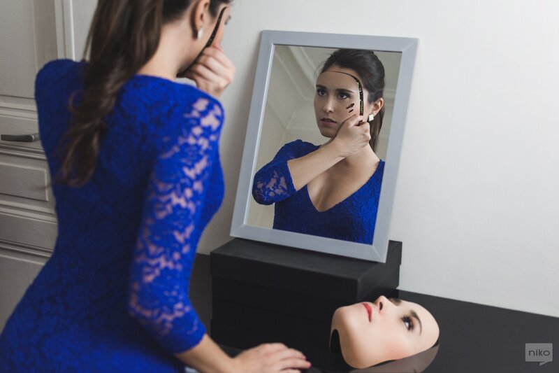 Woman Applying Makeup — Blue