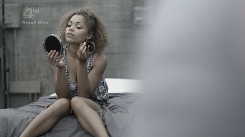 woman applying makeup on bed