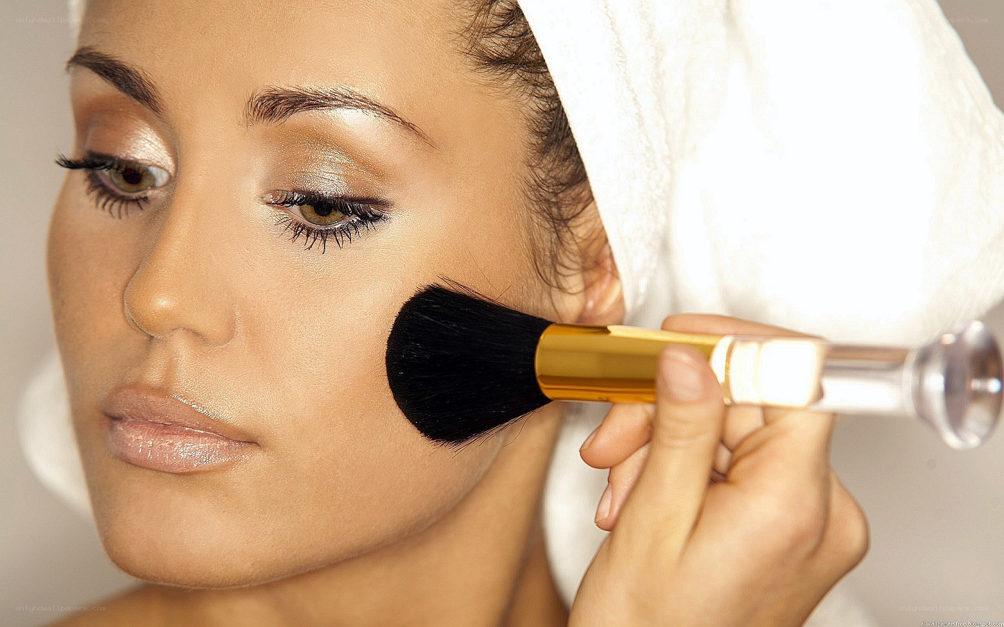 woman applying makeup with brush