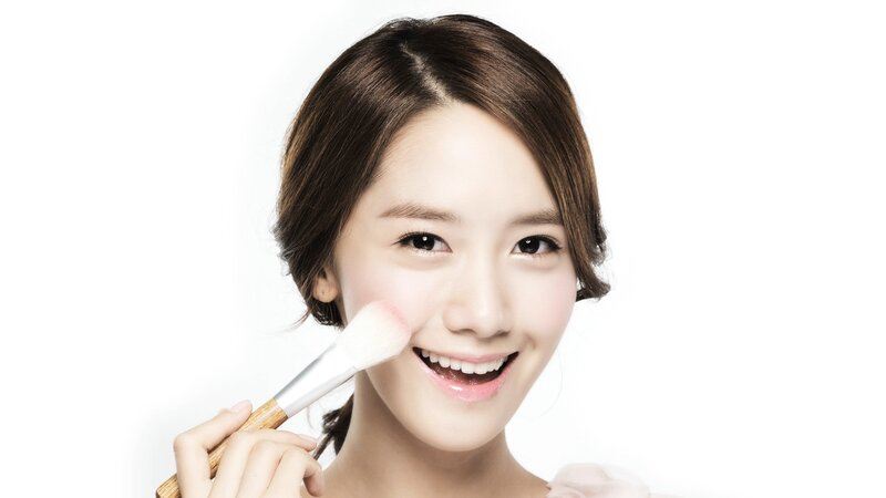 woman applying makeup with brush
