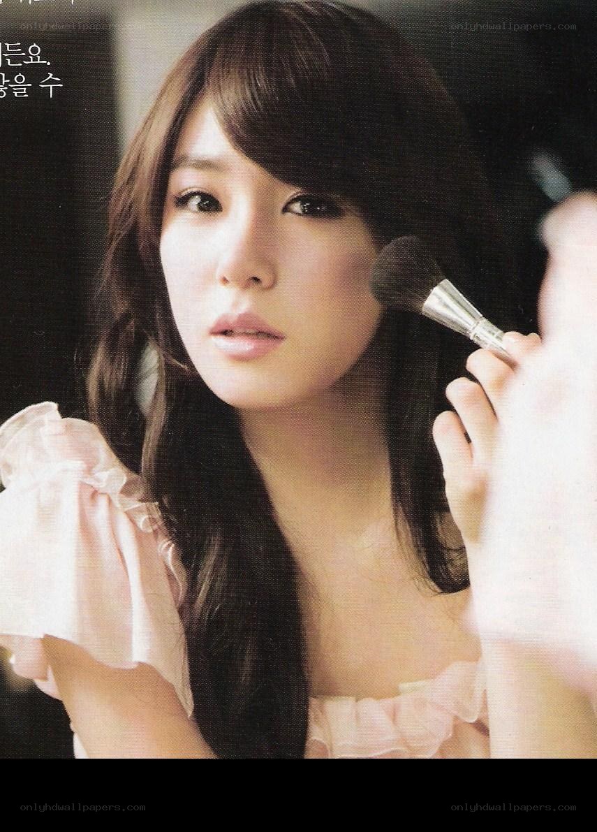 woman applying makeup with brush