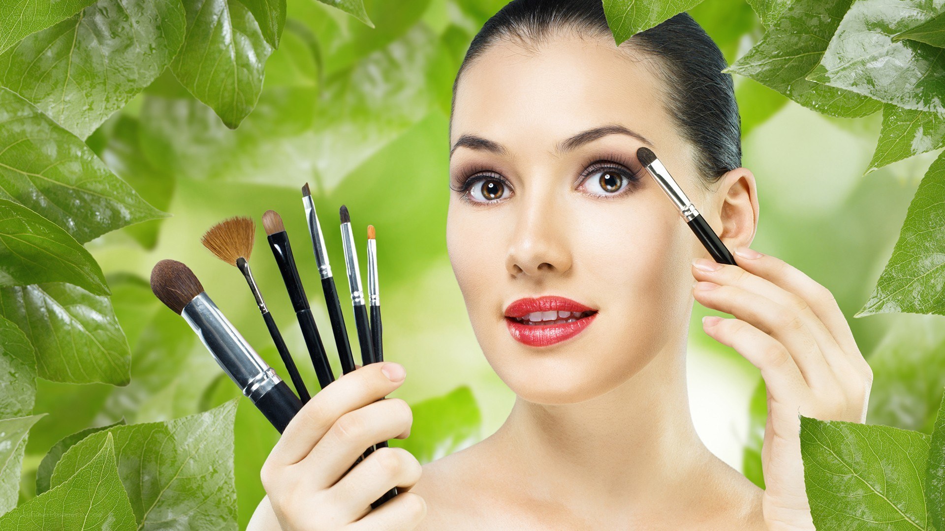 woman applying makeup with brushes