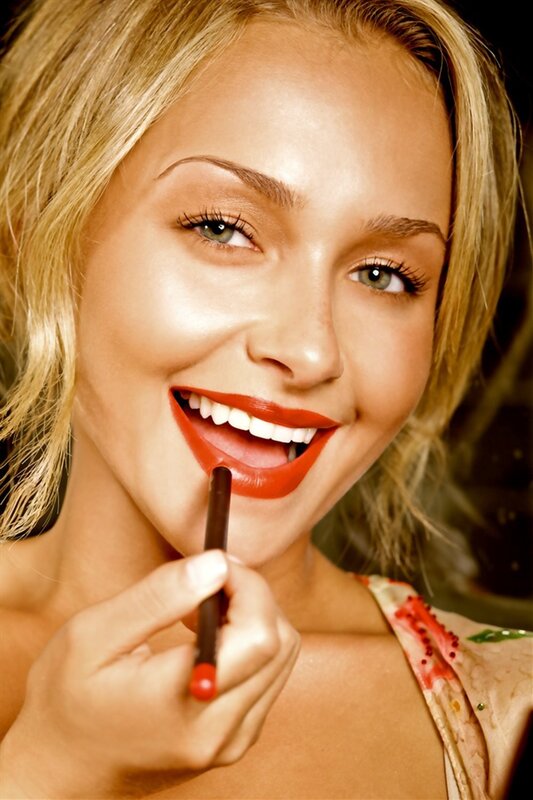 woman applying red lipstick