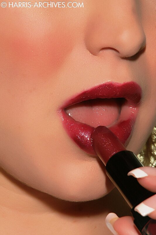 woman applying red lipstick