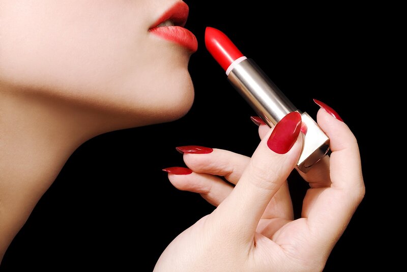 Woman Applying Red Lipstick — Dramatic