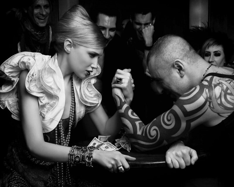 Woman arm wrestling man