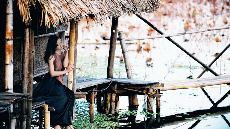 woman at a bamboo hut