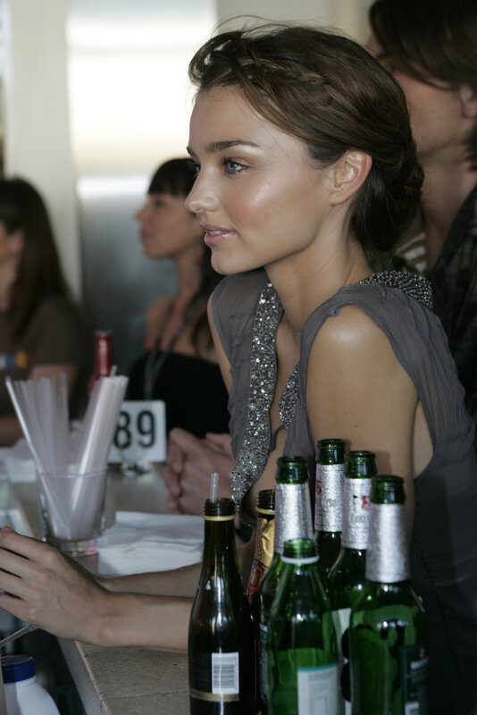 Woman at a bar with bottles
