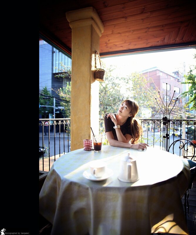 Woman at a cafe table