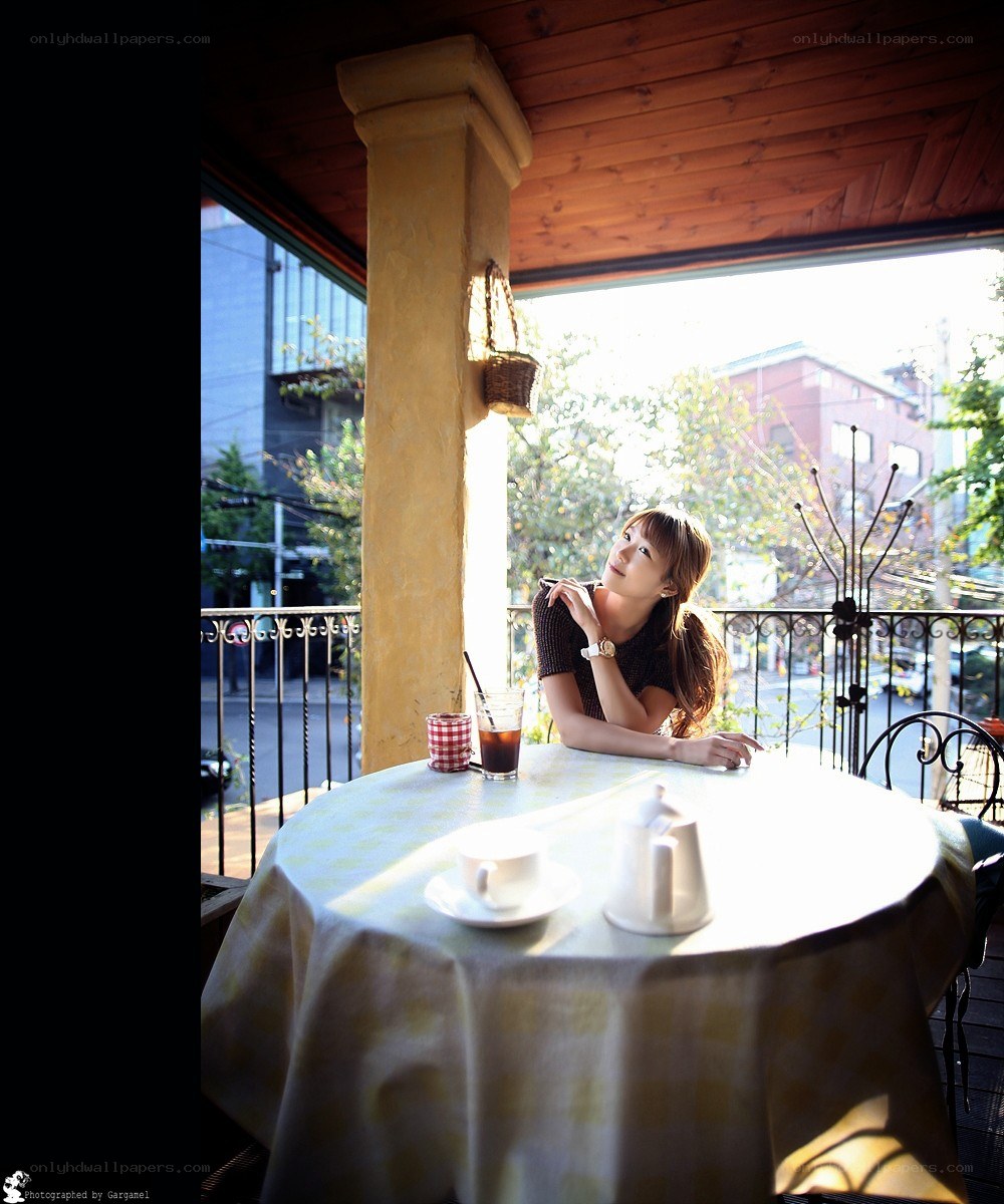 Woman at a cafe table