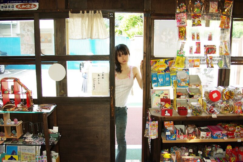 Woman at a candy shop doorway
