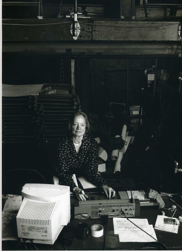 woman at a cluttered desk