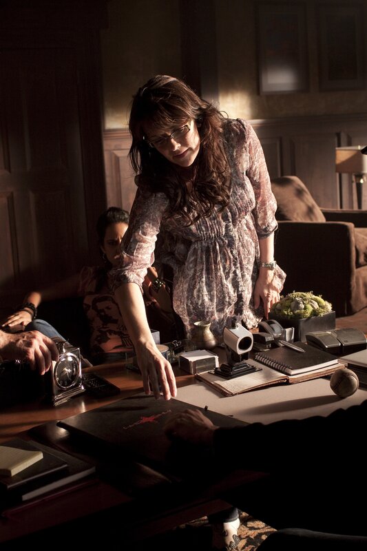 Woman at a cluttered desk