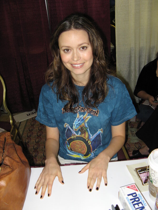 woman at a convention signing