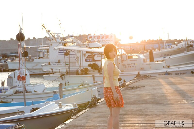 Woman at a harbor at sunset
