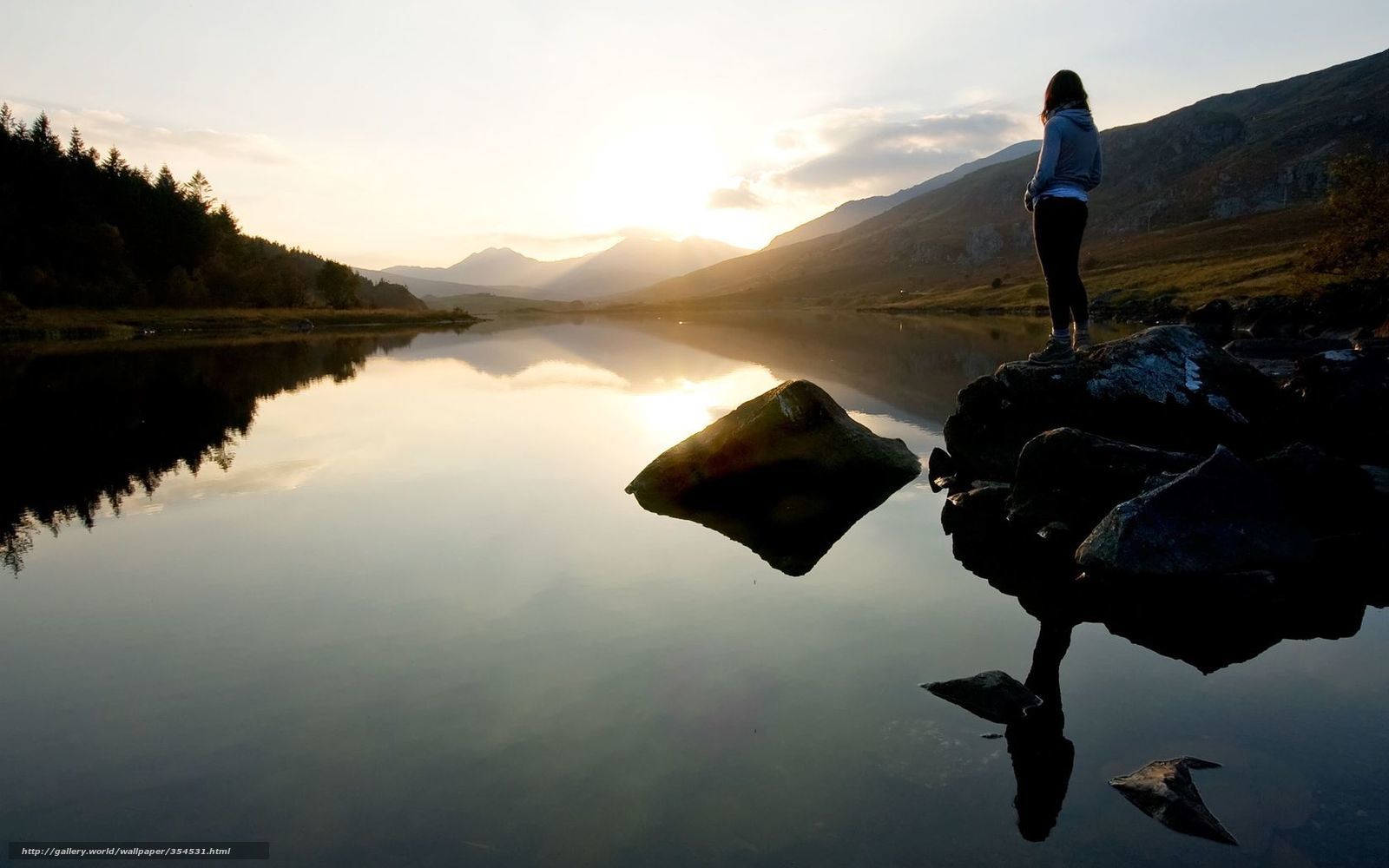 Woman at a lake at sunset
