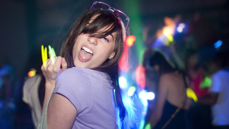 woman at a party with glow sticks