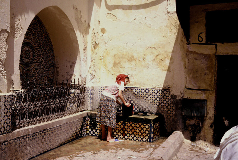 Woman at a public fountain