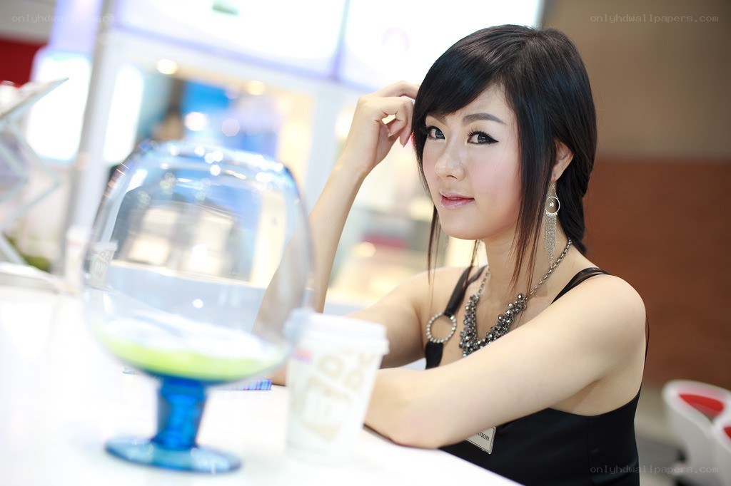 woman at a table with drink