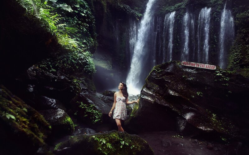 Woman at a waterfall in the jungle