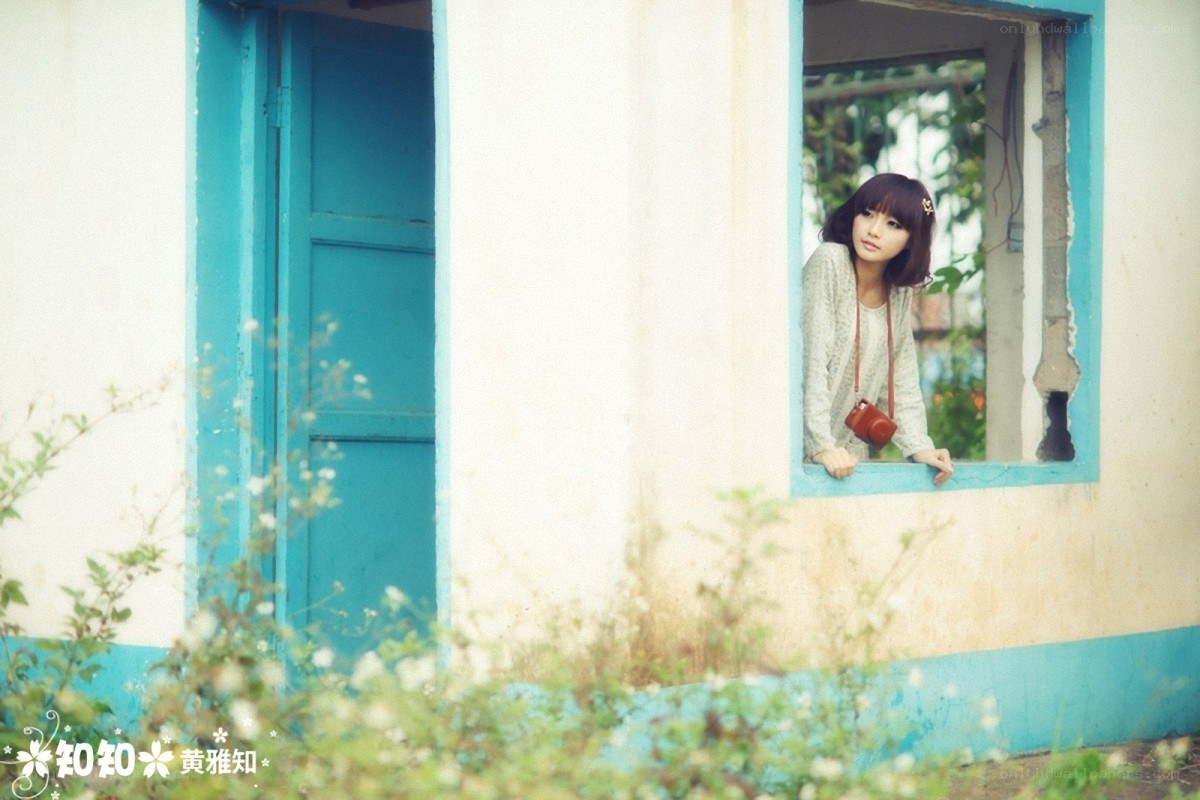 Woman at a window with camera