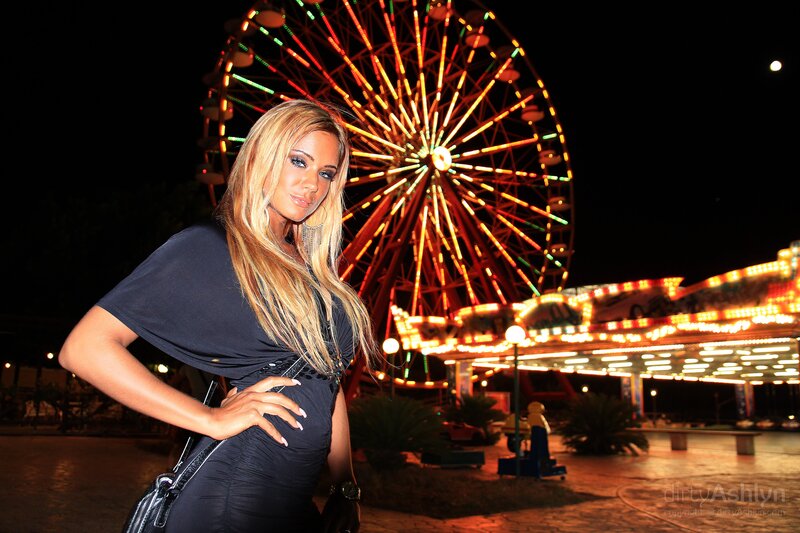 Woman at amusement park at night
