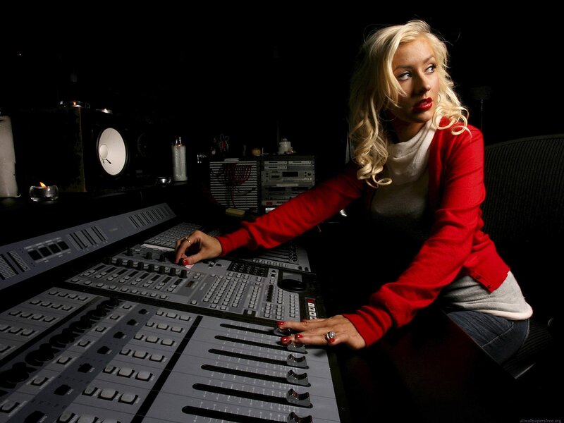 woman at audio mixing console