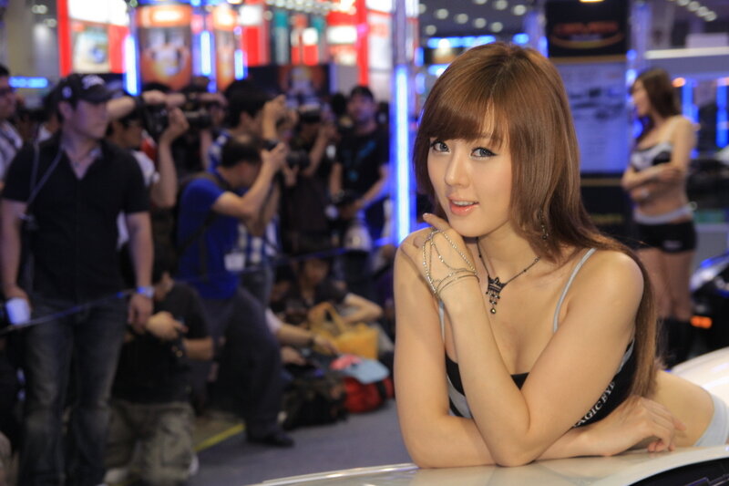Woman at Auto Show — Brown